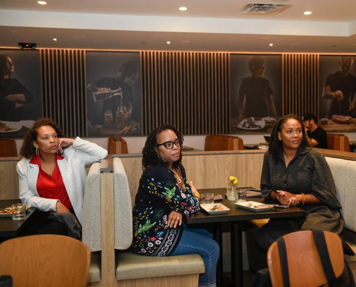 The Nonprofit Capacity Building Program participants and advisors meet during an event at Café Momentum.