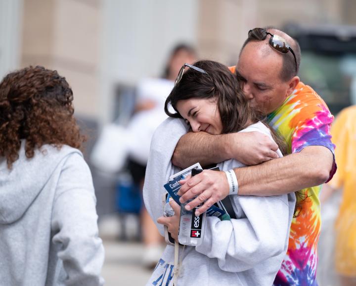 An incoming first-year student gets an encouraging hug from dad during Pitt Arrival.