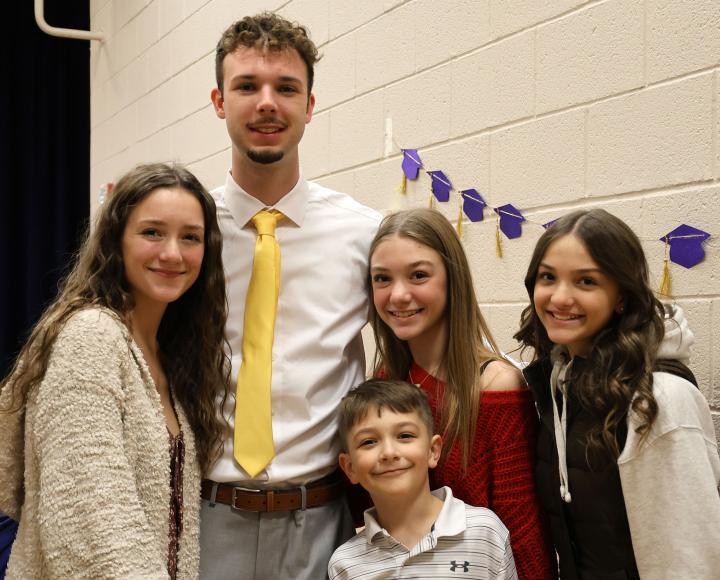 A graduate poses with loved ones during the Pitt-Greensburg winter commencement celebration.