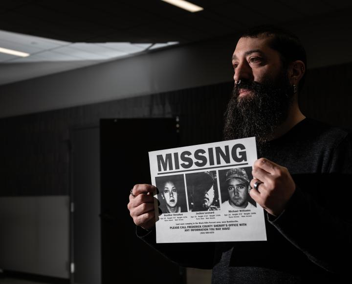 Rubin holds up a missing person poster