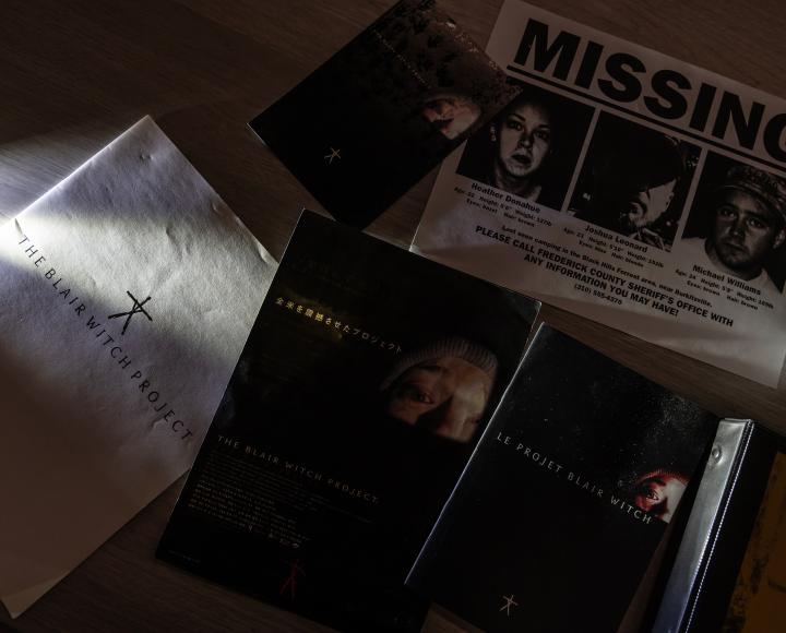 Pamphlets and paper materials from "The Blair Witch Project" on a table.