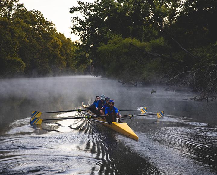 Pitt students rowing on the river