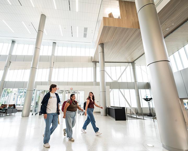 Students walk through the front door of the Hillman Library