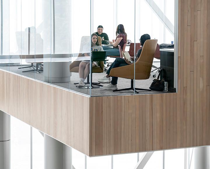 Students sitting around a table by a window