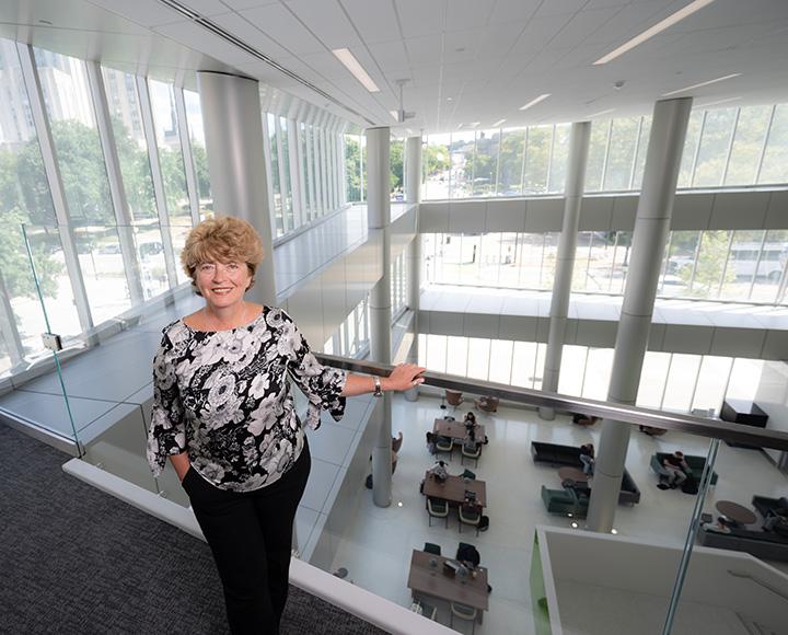 Tancheva stands on a staircase overlooking the library entrance.
