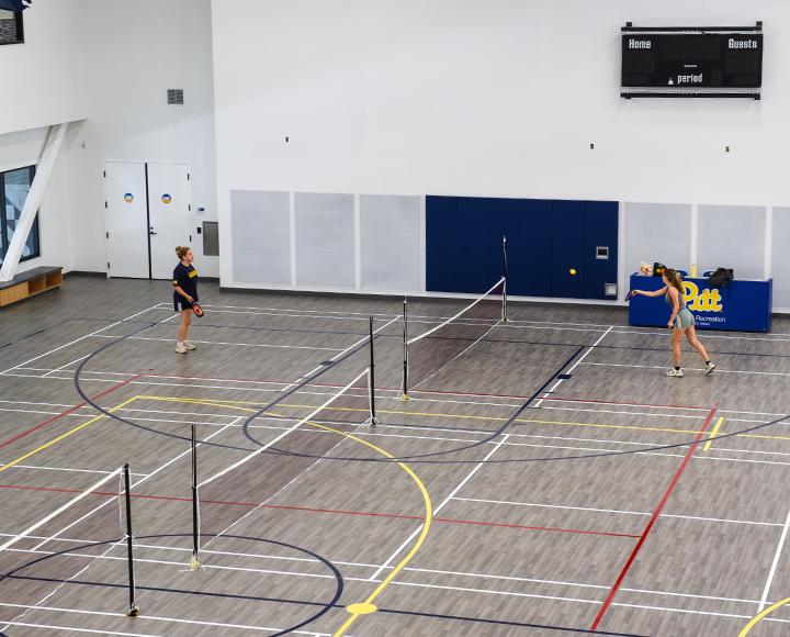 Two students playing on an indoor court