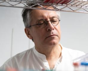 Pitt reasearcher looking at test tubes