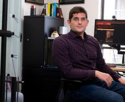 Morgan Frank sits at his office desk