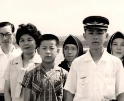 A black and white photo of a family