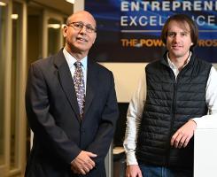 Brent Rondon and Roberto Bellido-Diaz stand in an office