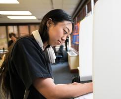 A student fills out a ballot at a mock voting booth