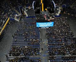 Confetti falls over winter commencement graduates and attendees.