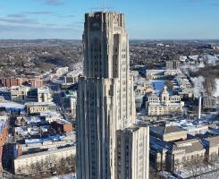 The Cathedral of Learning stands over the Oakland neighborhood on a snowy day
