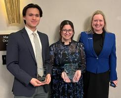 Simon Wang and Lauren Delsignore hold awards