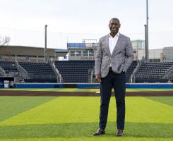 Portrait of man standing on field of baseball stadium.