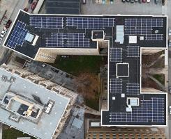 Many solar panels on a rooftop