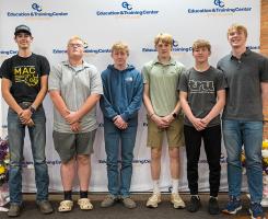 Titusville students standing in front of a screen reading Education & Training Center