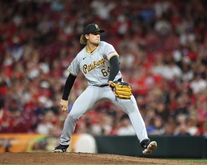Baseball player throwing a pitch in a crowded stadium.