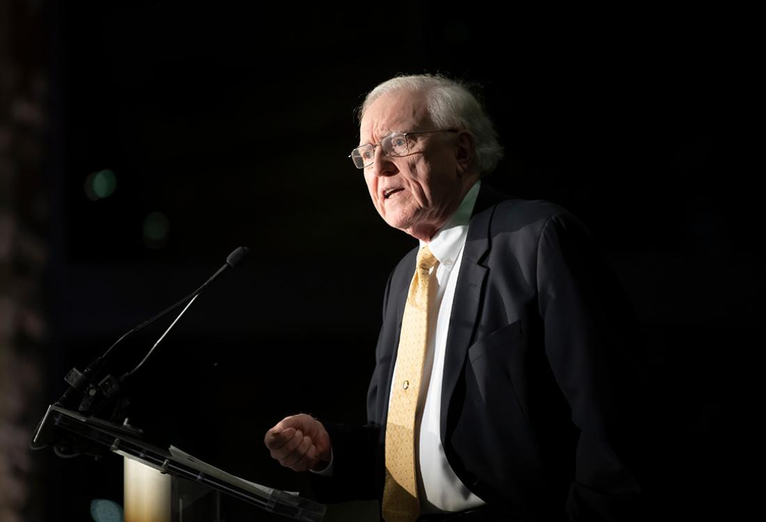 Maher speaks at a podium