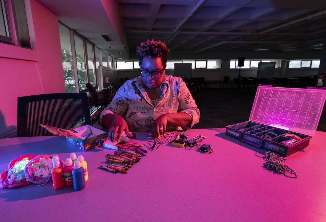 Woman builds robot at a table