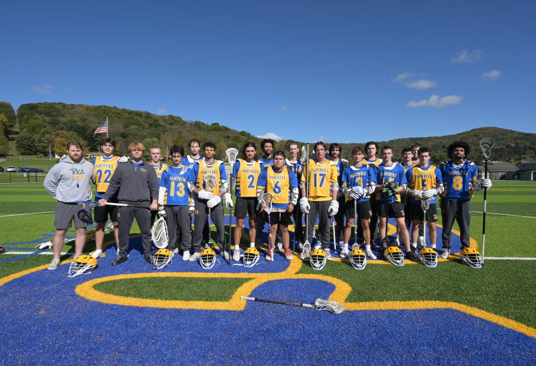 Lacrosse team lines up on the field for photo