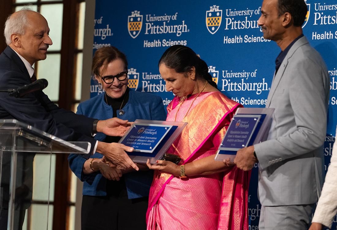 Shekhar and Gabel present plaques to Vardhini and Vardhan