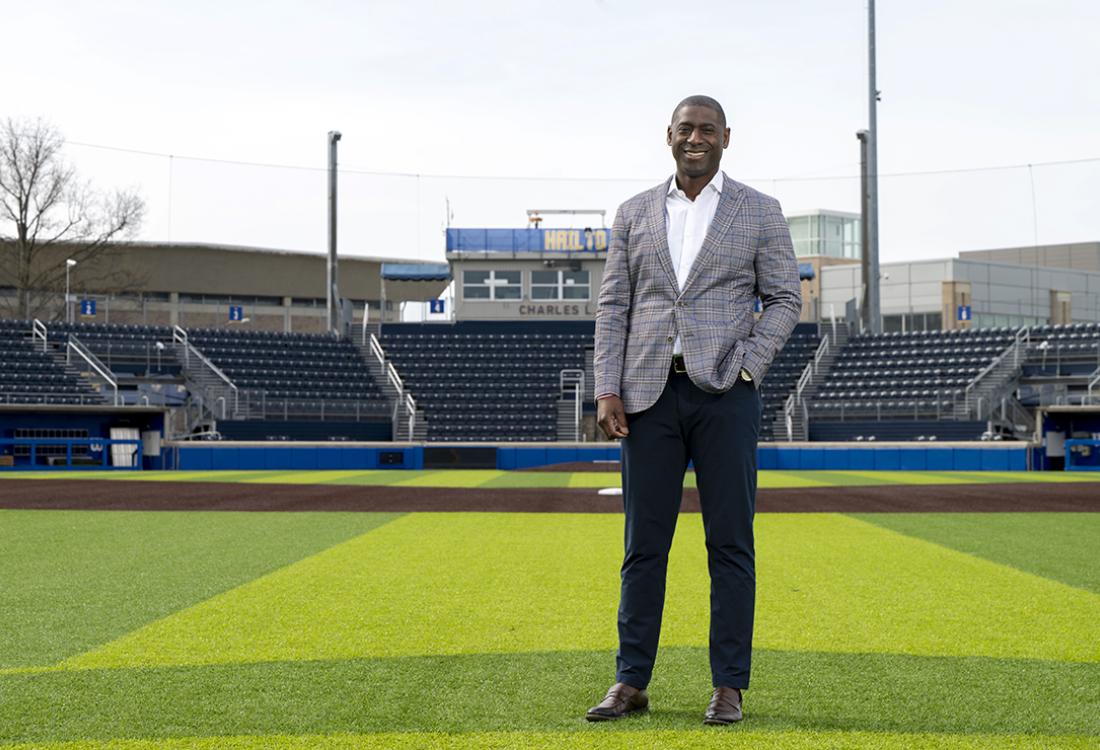 Portrait of man standing on field of baseball stadium.