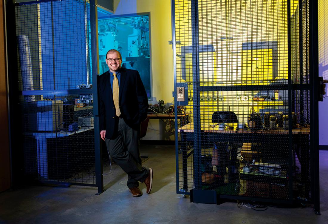 A man poses for a photo in a research facility.
