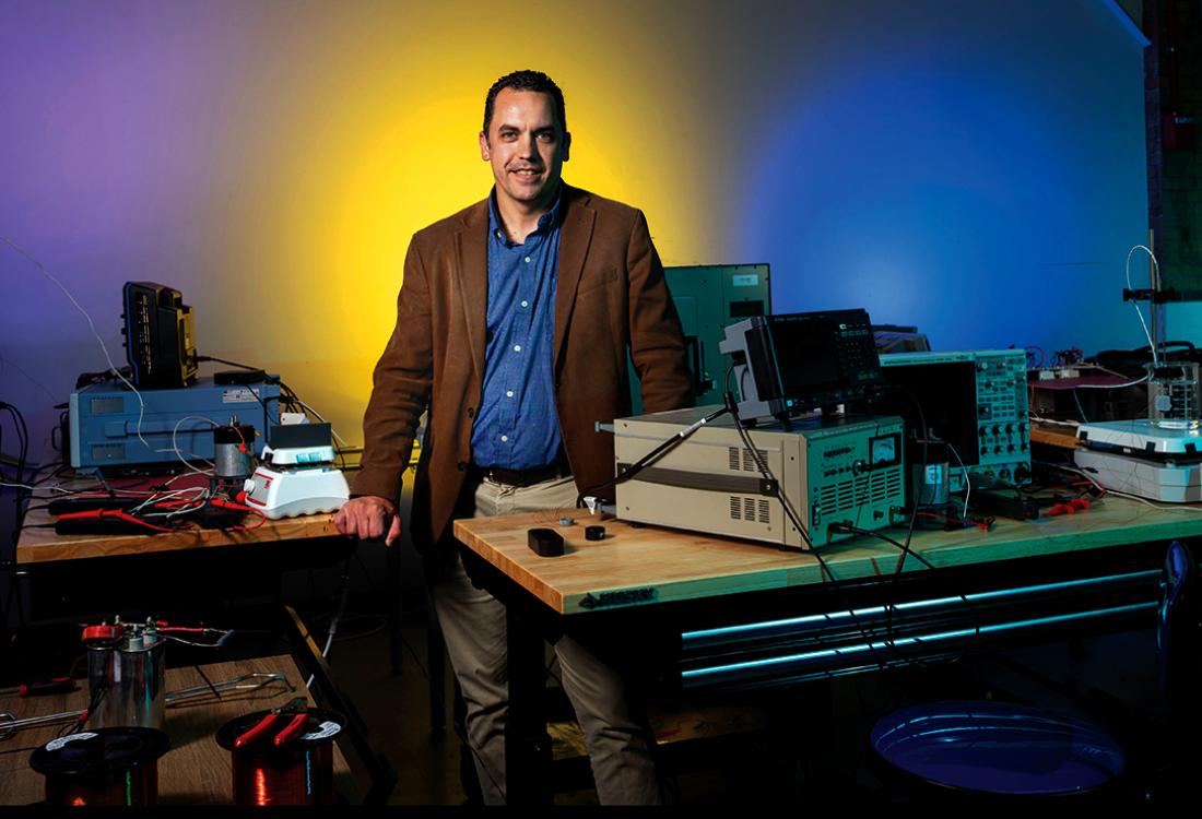 A man poses for a photo in a research facility.