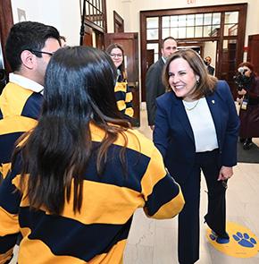 Gabel shakes hands with students