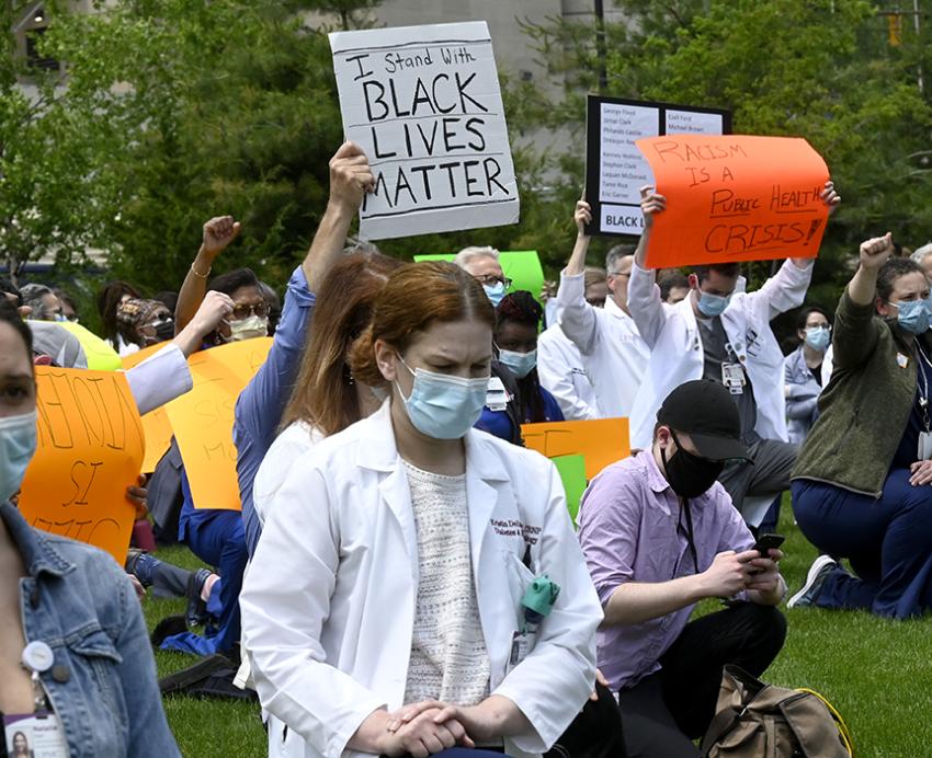 People in white lab coats protest for Black Lives Matter