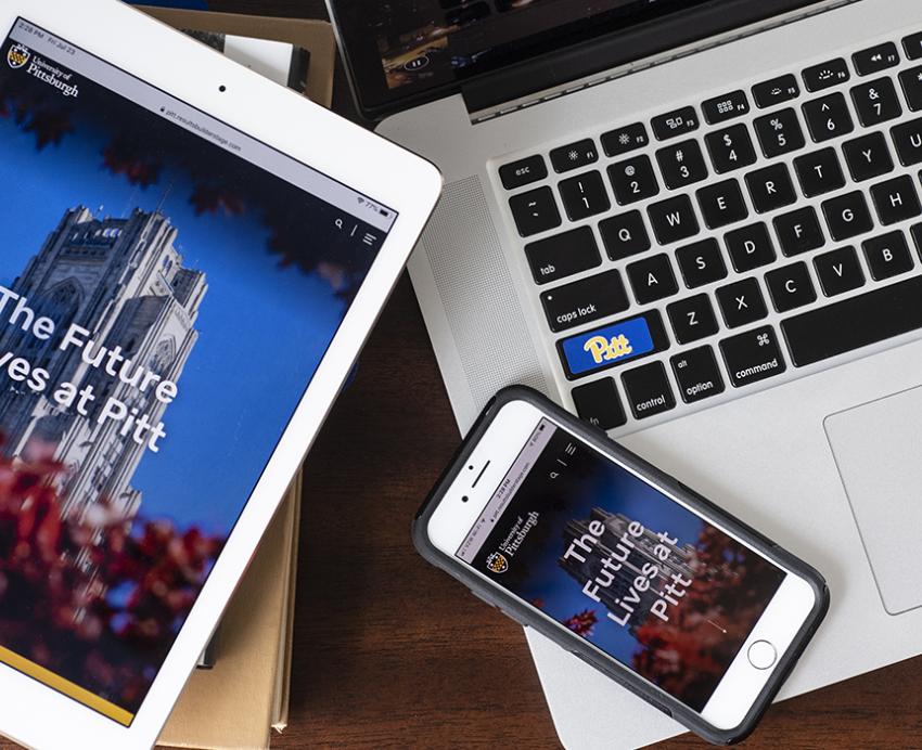 a laptop, tablet and phone with the new pitt.edu website pulled up