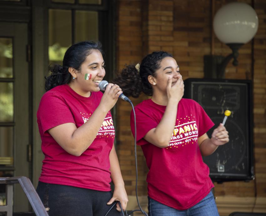 Two women in red "Hispanic Heritage Month" shirts
