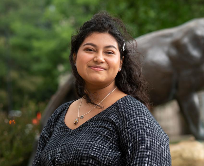 Jennifer Espinoza wearing black shirt with panther statue in background