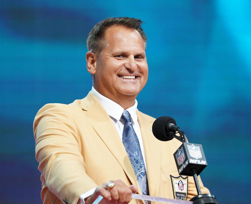 Jimbo Covert in a tan suit