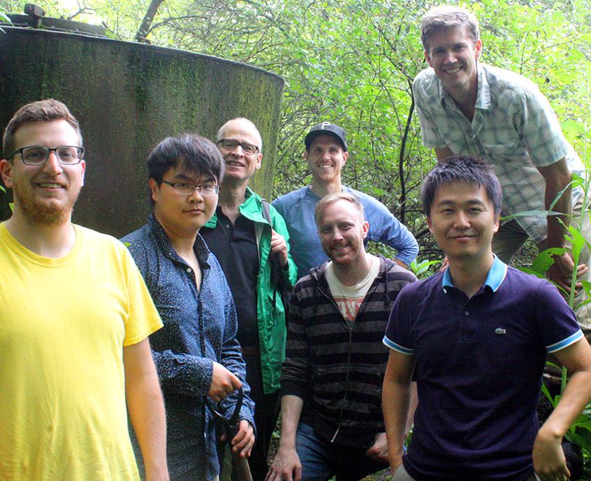 GSPIA students grouped together, smiling in the woods 