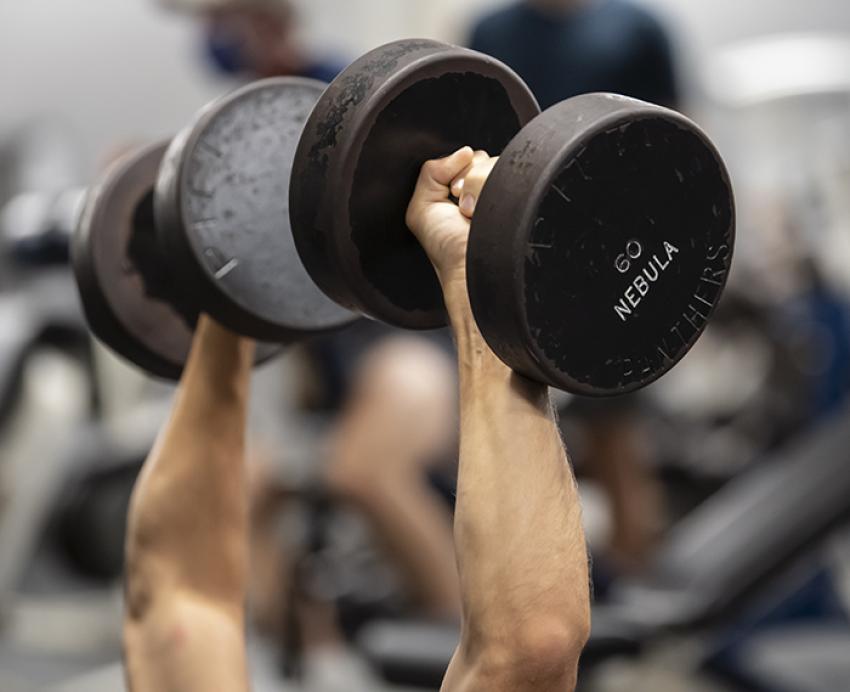Person lifting 60 pound dumbbells 