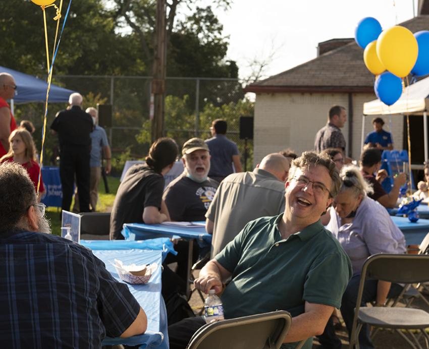 Oakland block party, decorated with gold and blue balloons