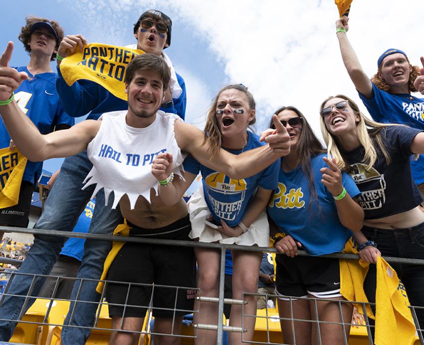 Pitt fans cheering with yellow Panther Nation towels