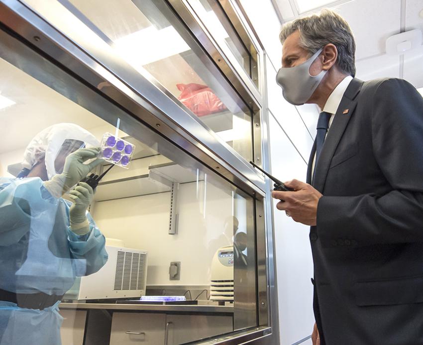 Blinken wearing face mask and suit visiting lab 