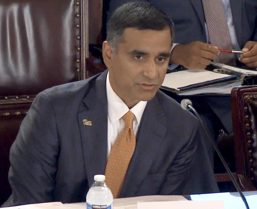Hari Sastry speaking into microphone during testimony