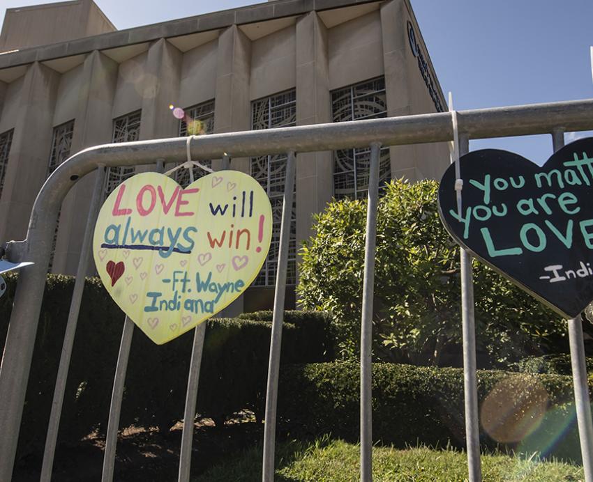 Heart-shaped signs attached to fence