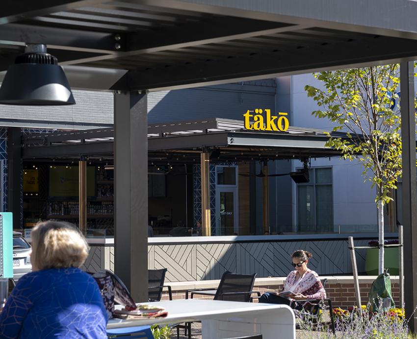 People sitting outside of Tako restaurant in Bakery Square