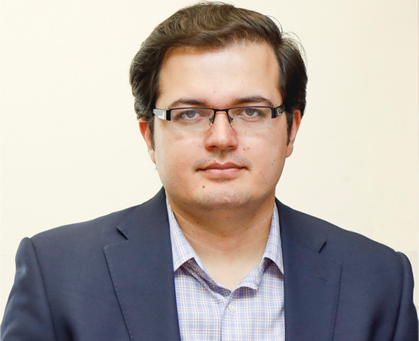 Ihsan Qazi wearing black suit with glasses