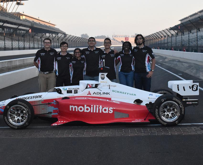 Pitt undergrads at Indianapolis Autonomous Challenge standing next to their car