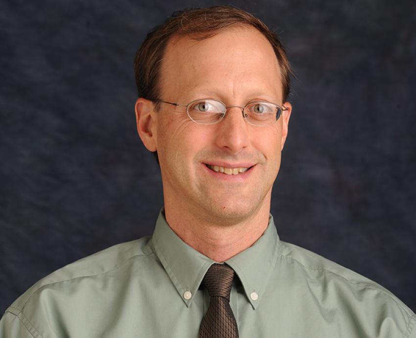 Todd Reeser wearing green shirt with black tie 