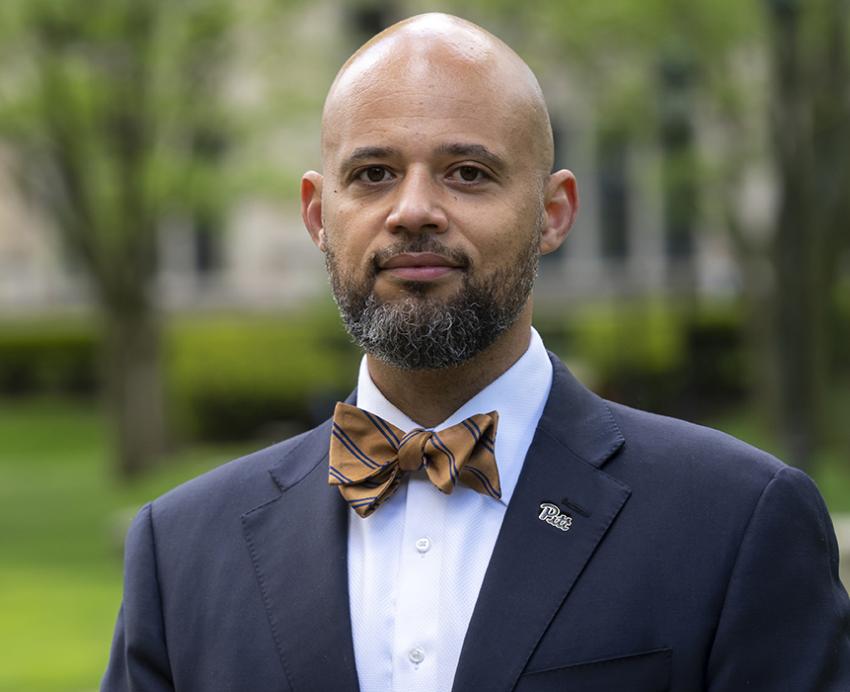 Clyde Pickett wearing suit and brown bowtie