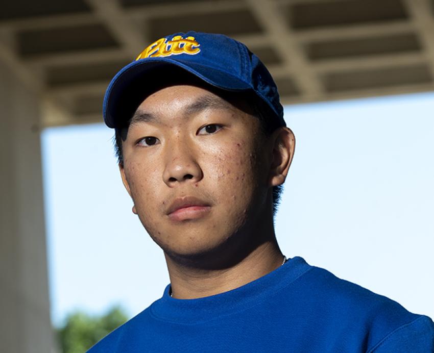 Richard Fang wearing blue Pitt hat and sweater