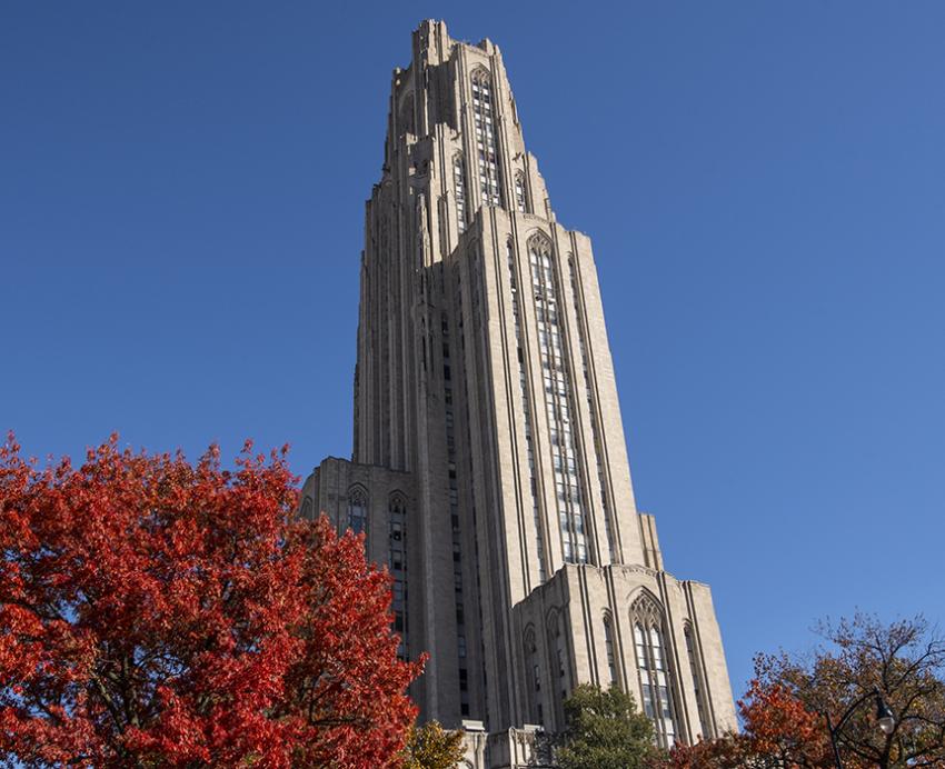 Cathedral of Learning behind trees during Fall