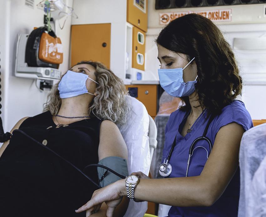 a nurse tending to a prone patient in an ambulance